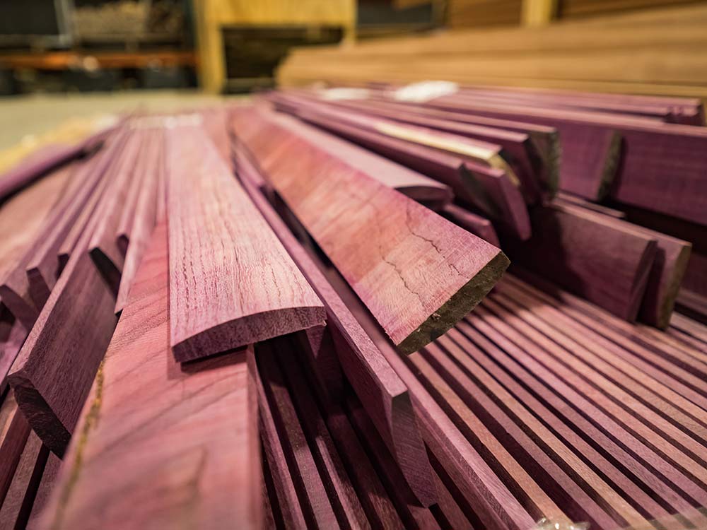 a stack of purple heartwood used to make turkey box calls