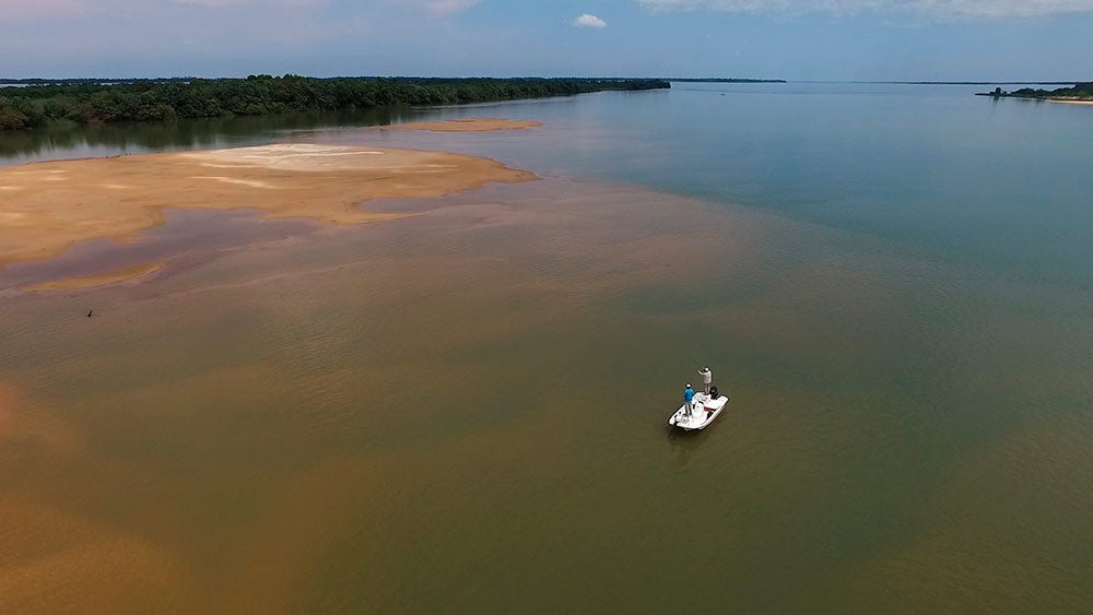 a drone image of a small boat on the upper parana river