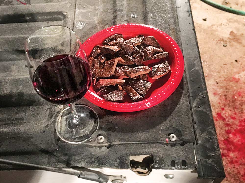 deer meat and wine on a tail gate