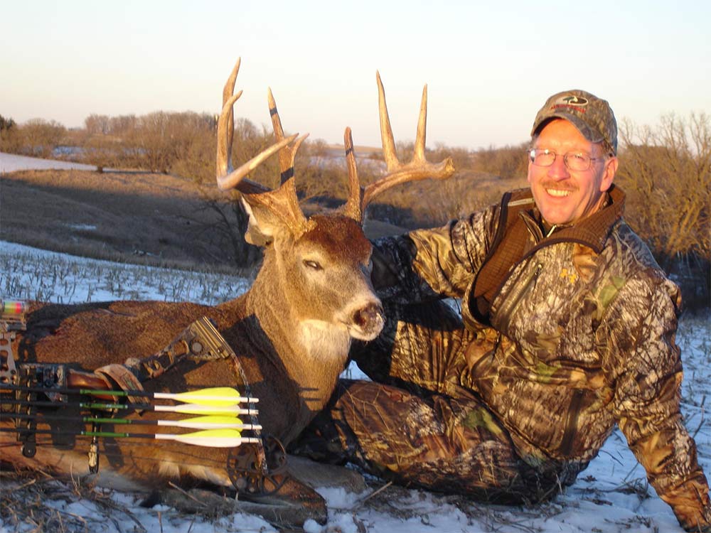 Bowhunter with an Iowa buck