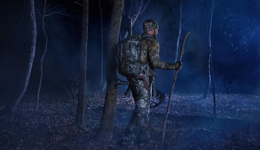 Deer hunter walking in the dark. 