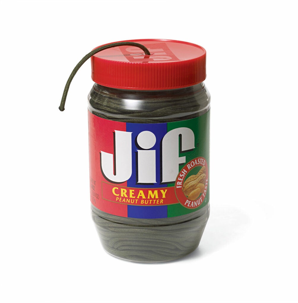 A jar of peanut butter with a string drawn out.