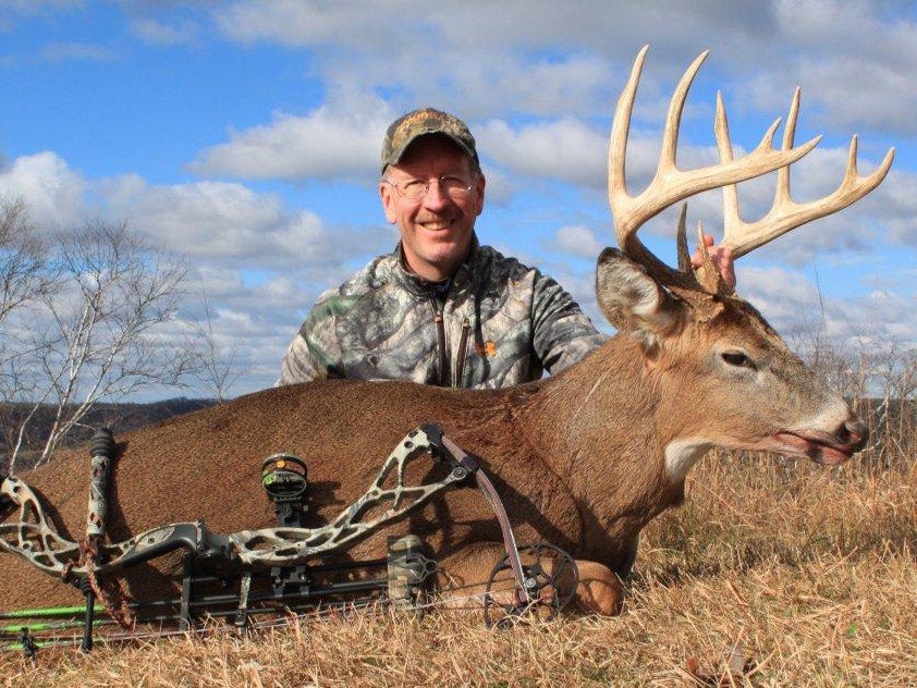 Bowhunter with a trophy buck
