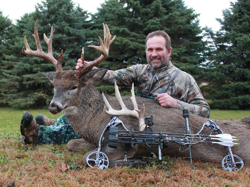 Bow hunter with a trophy buck