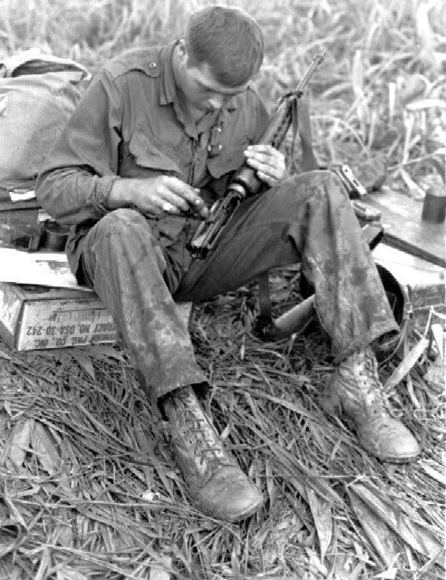 united states soldier cleans M16 vietnam war