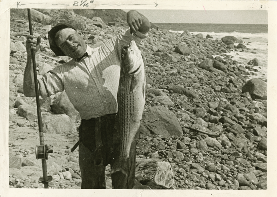 A black and white image of a northeast angler fishing striped bass.