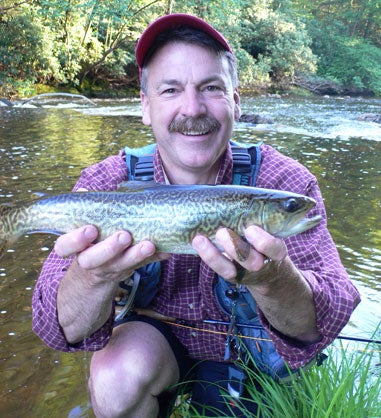 man holding up a trout