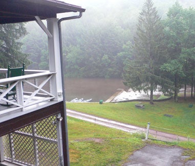 view of rain on cabin porch