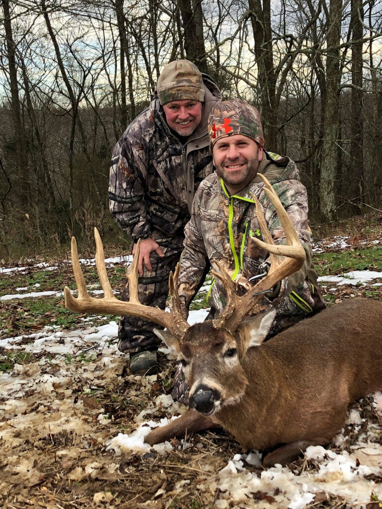 Jason Koger with a friend and buck
