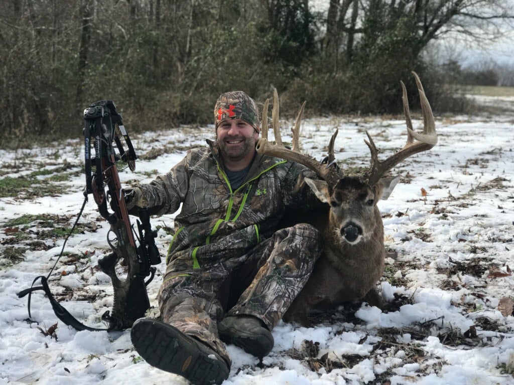Jason with the buck and his crossbow