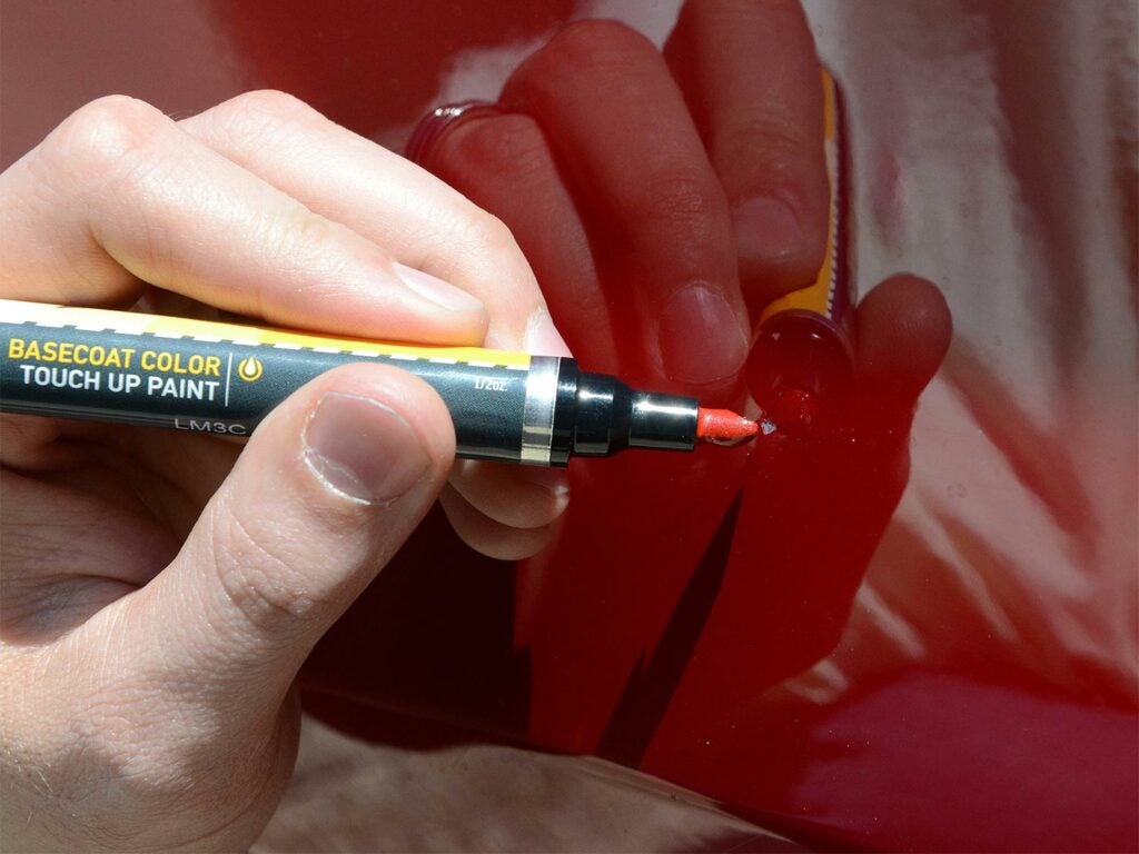 using a paint repair pen to fix car
