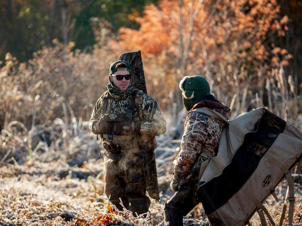 two hunters hauling hunting gear