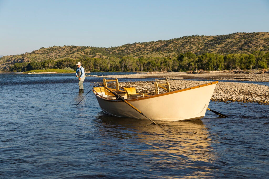A Boulder Boat Works drift boat waits for a fly angler.