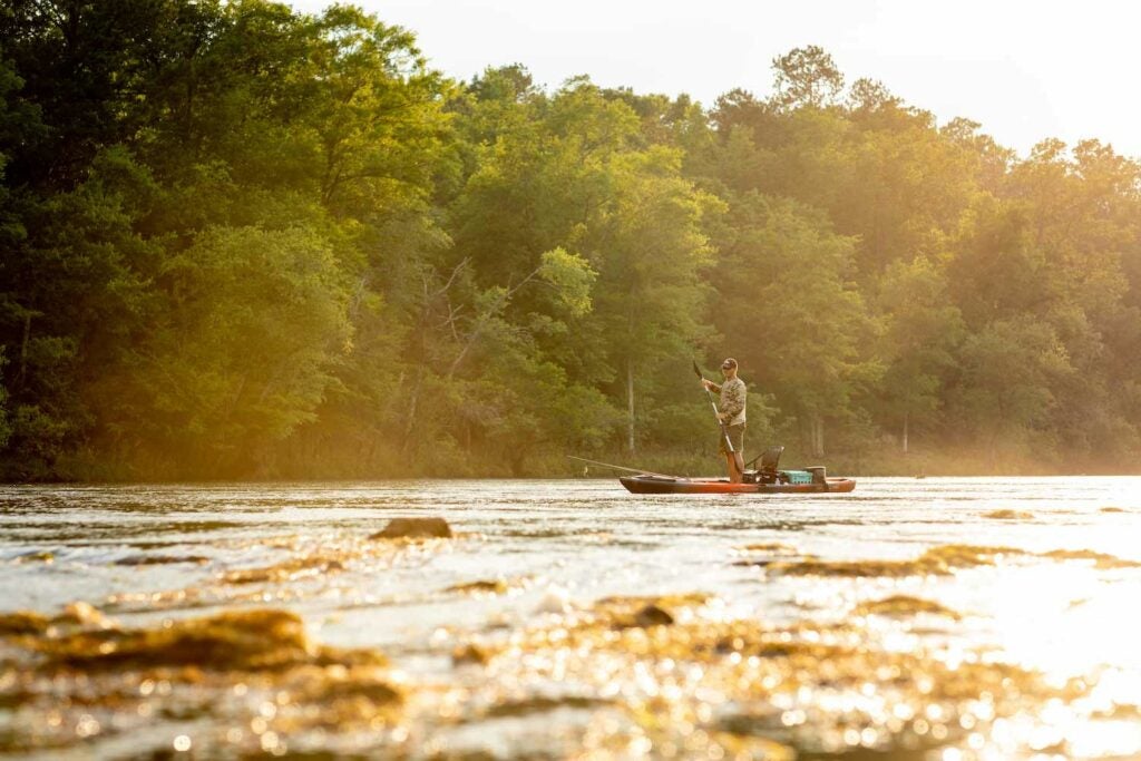 Cody Wade paddles through a sunny stretch of the Flint River, in Georgia.