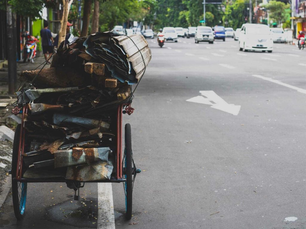 Roadside cart topped with a bundle of junk