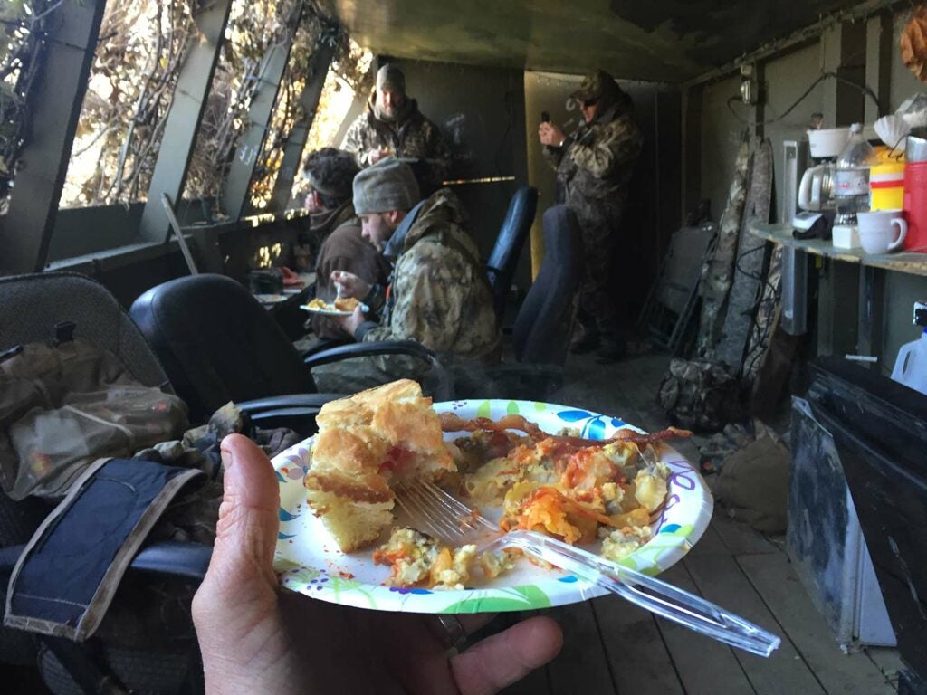 hunters eating in a duck hunting blind