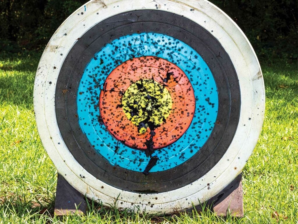 a bowhunting target covered in holes