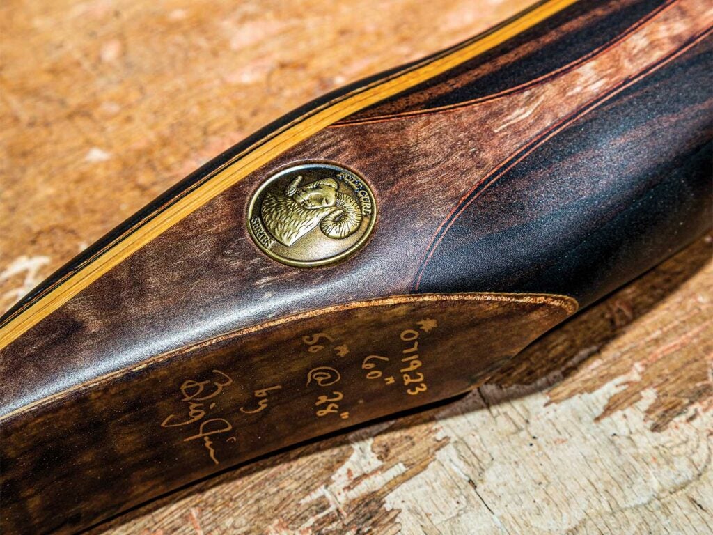 Full Curl recurve bow with a coin embedded in it