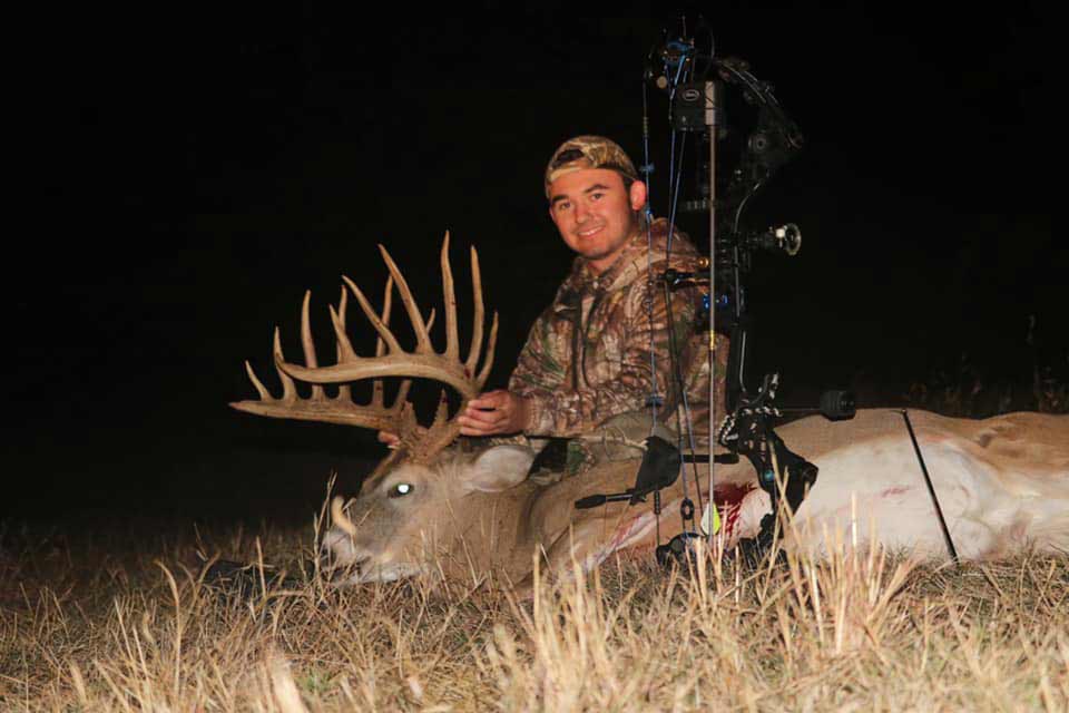 hunter with a whitetail buck