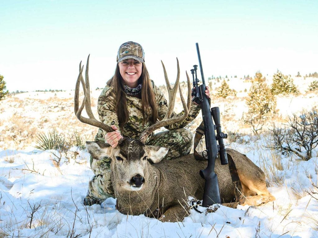Erika Meister with a whitetail buck in the snow.