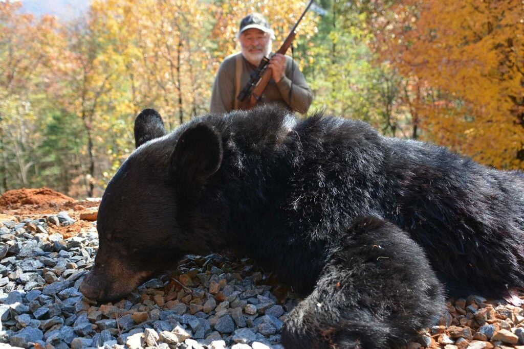 hunter with a giant black bear