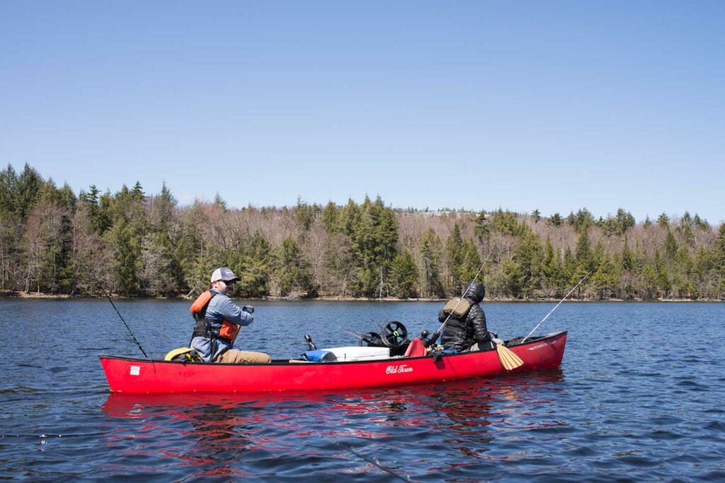 Two paddlers navigate a lake in Upstate New York, on the Northern Forest Canoe Trail.