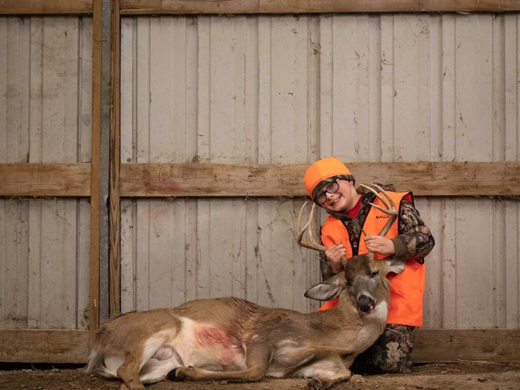 Nine-year-old Gryffin Raben shot his first buck from a folding chair tucked into tall grass.