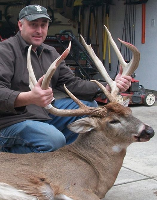hunter with a 9-point trophy buck