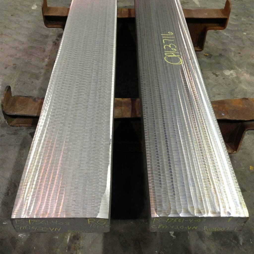 Slabs of CPM S30V steel heading to rerolling into sheets.