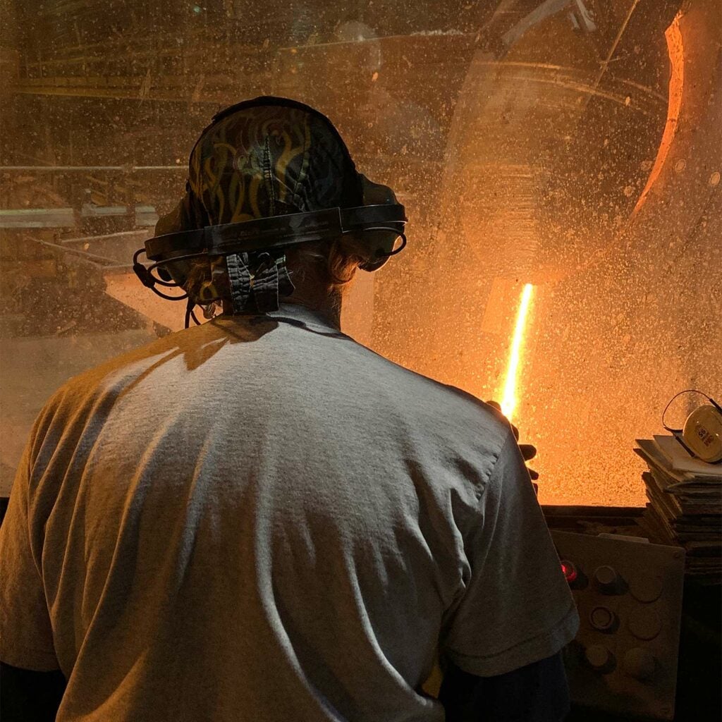 View from the induction furnace operator station. Steel is being melted in an induction furnace.