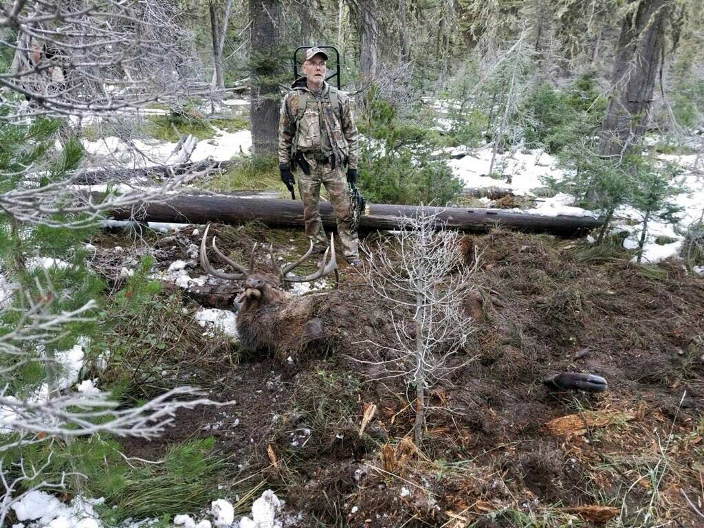 Hunter standing beside hunt that has been buried by grizzly bear.