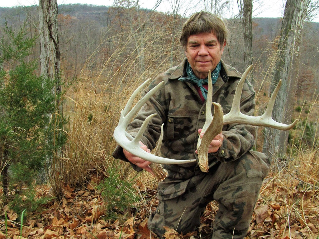 Author holding up two shed antlers.