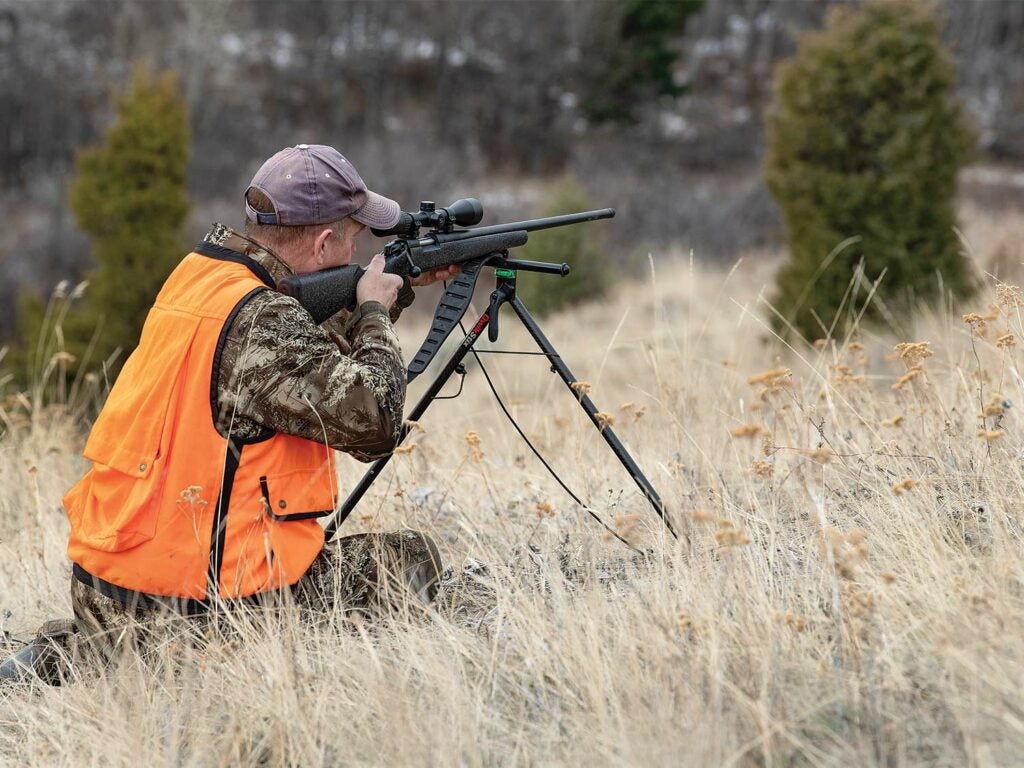 Hunter aiming a rifle with a bipod.