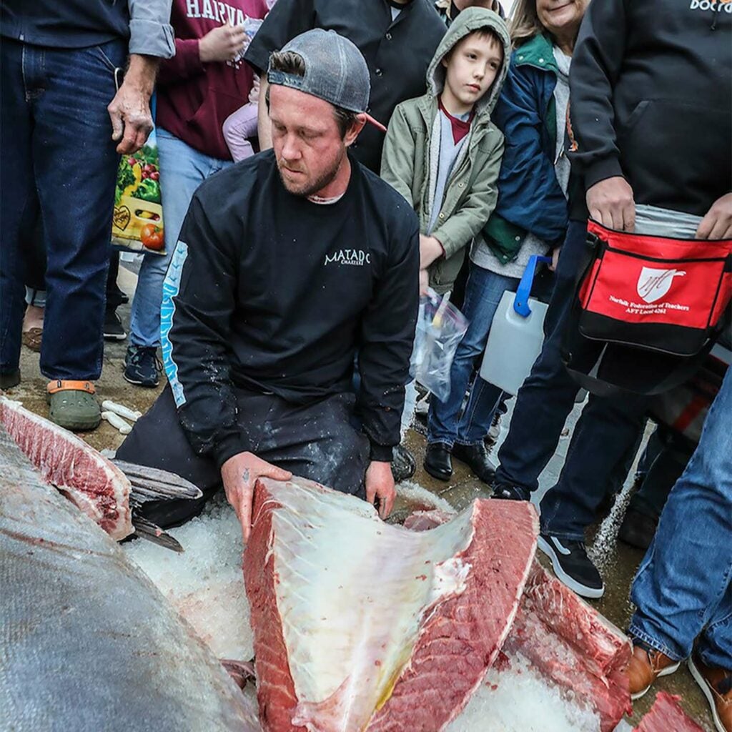 Man carving bluefin tuna steaks.