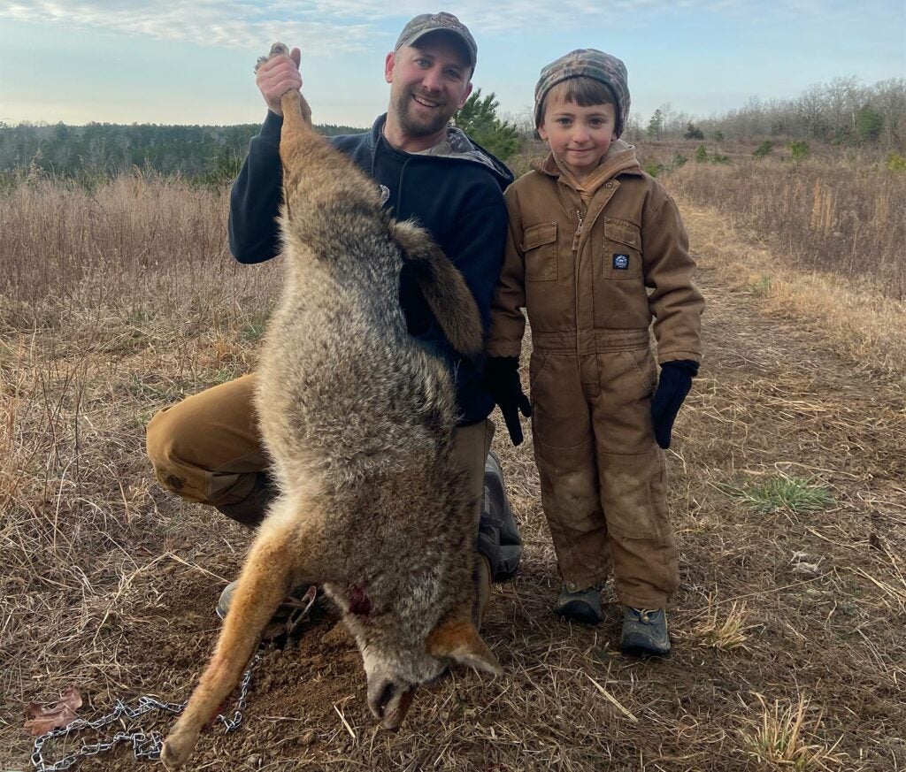 Author and son trapping a coyote.