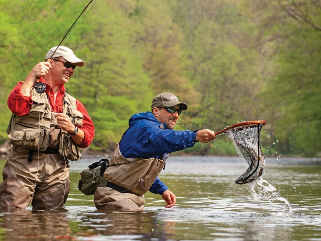 Anglers using net while fishing.