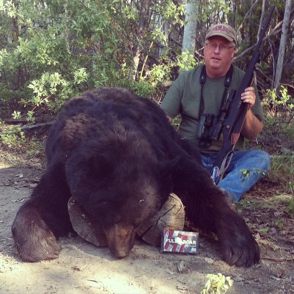 Hunter with a large black bear.
