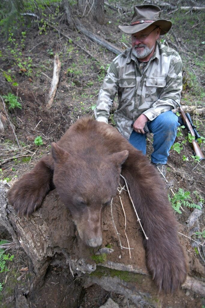 Hunter with a large color phase black bear.