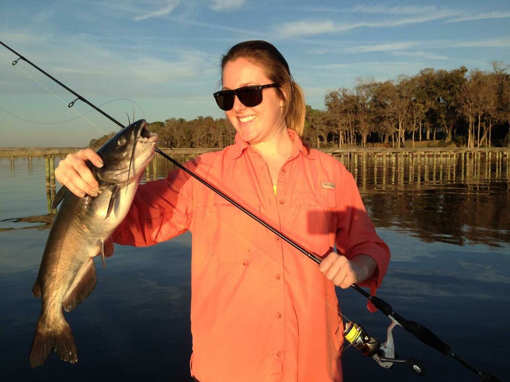 Female angler holding a channel catfish.