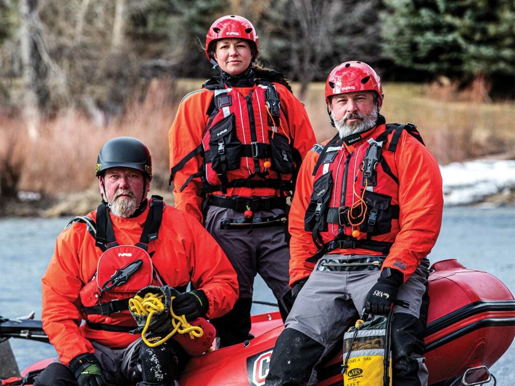 A search and rescue team near an inflatable Zodiak raft.