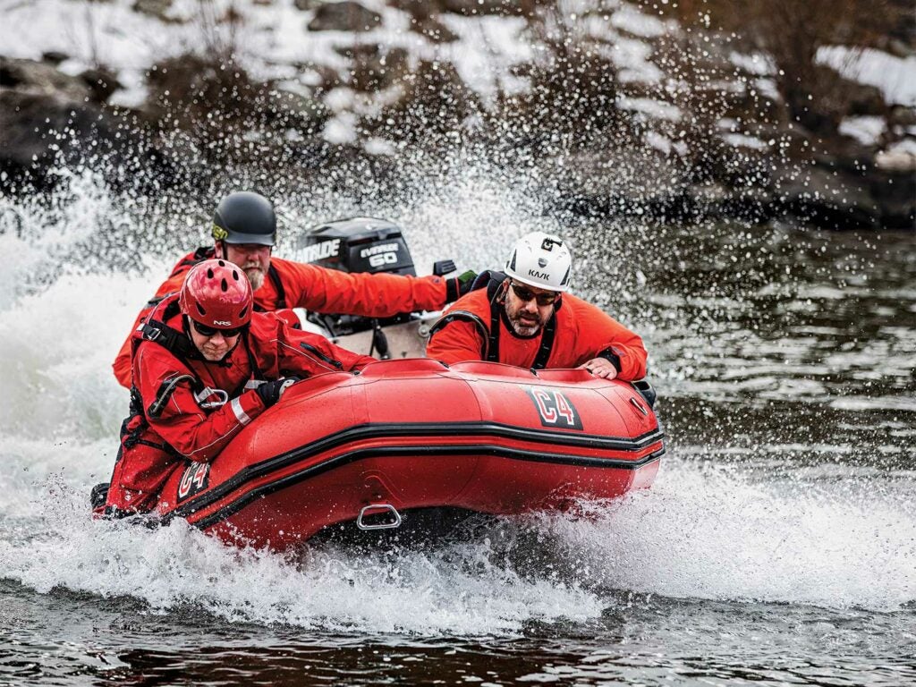 A search and rescue team on an inflatable zodiac on Clark Fork River.