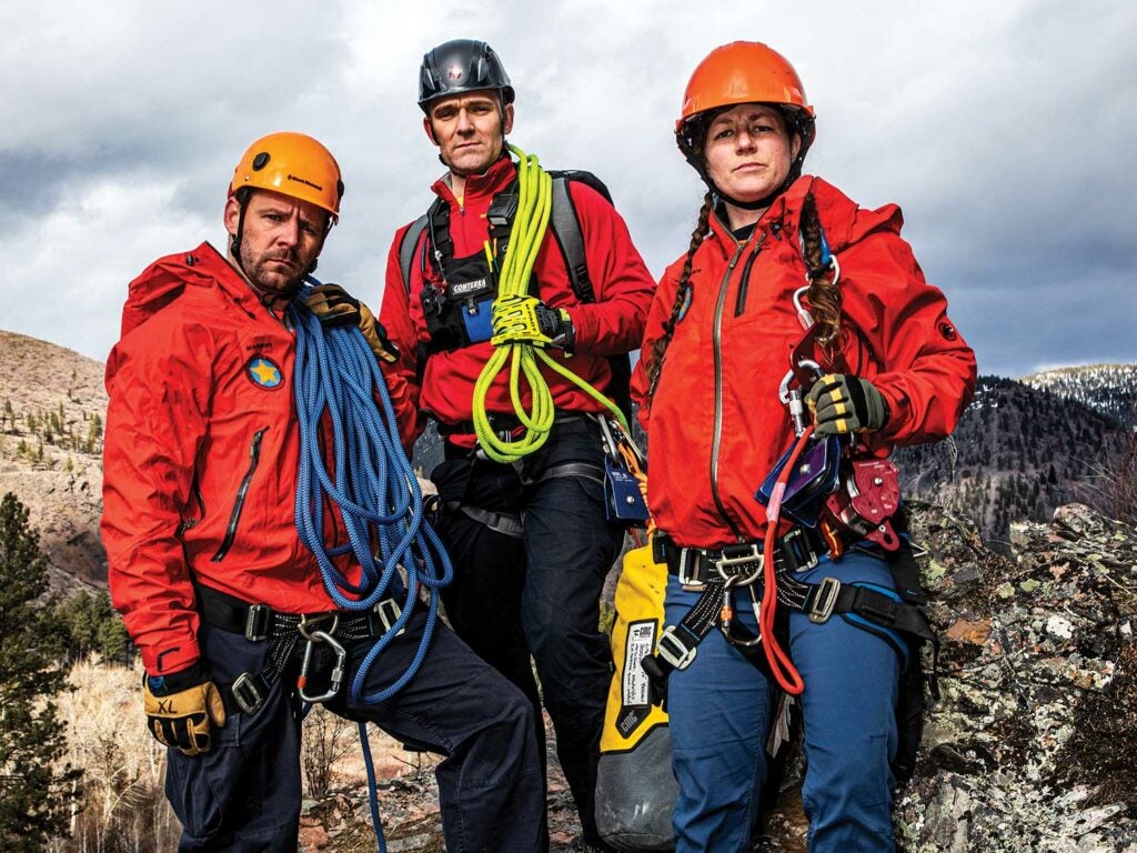 A team of search and rescue personnel with climbing equipment.