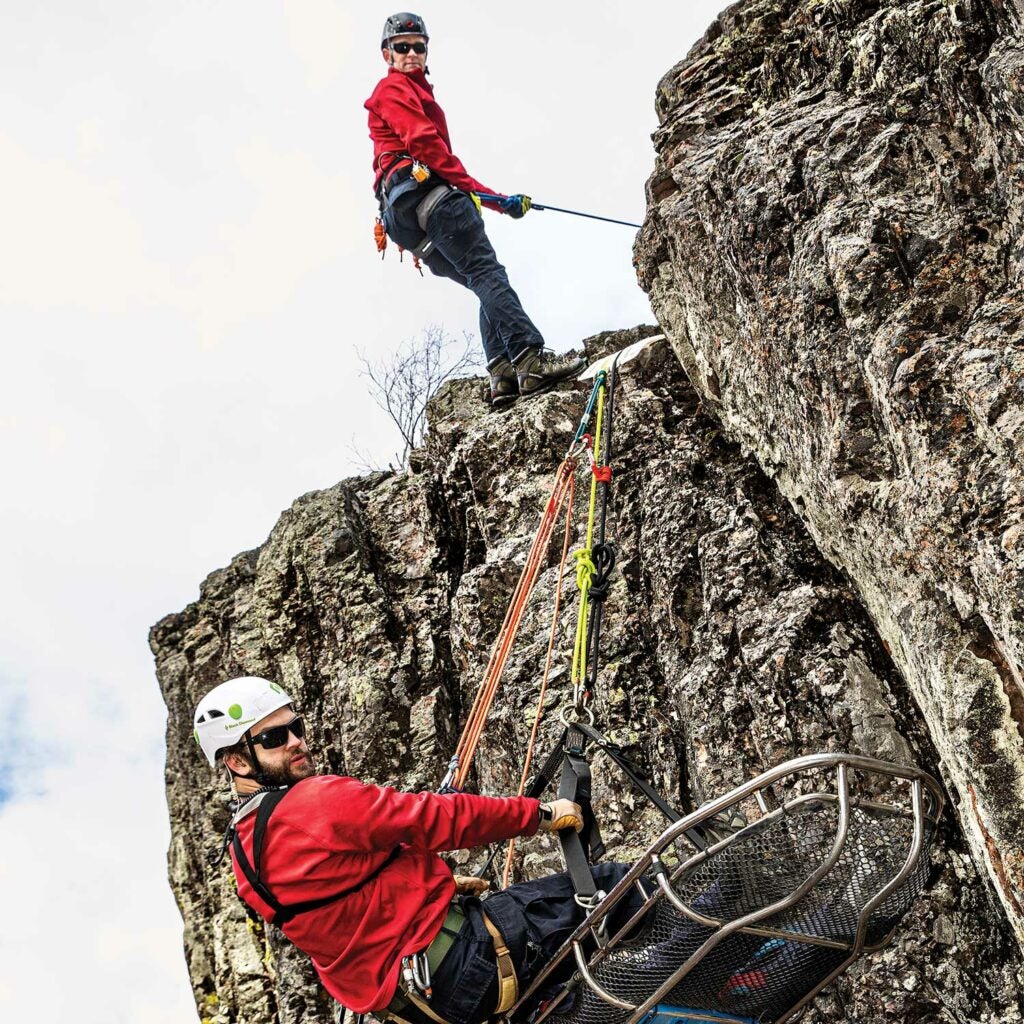 A team of search and rescue personnel training for cliff climbing.