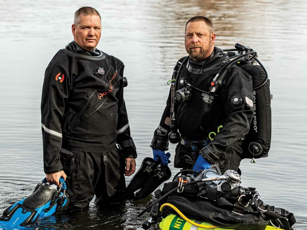 Two diving members of a search and rescue team prepare for a dive.