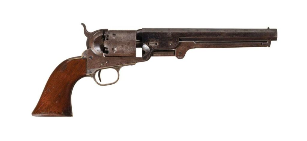 A percussion Model 1851 Navy Revolver made in 1857 on a white background..