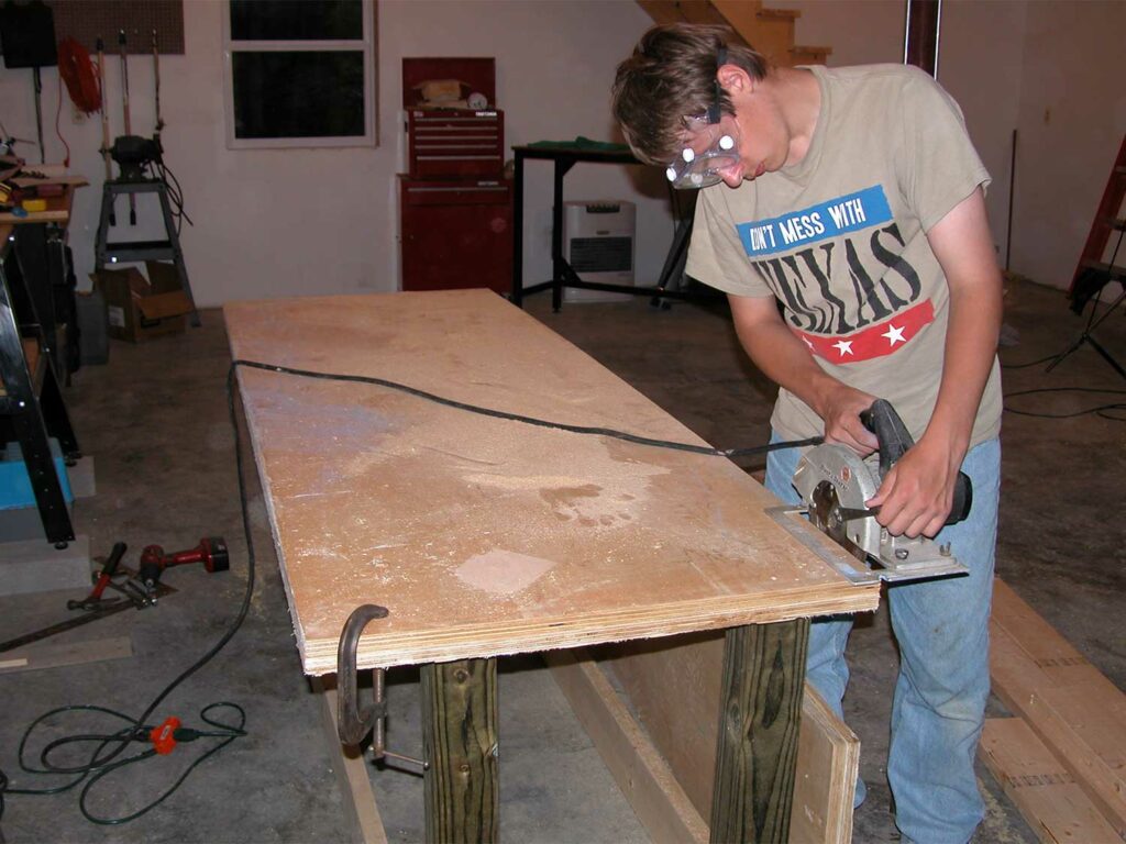A man building a long custom table.