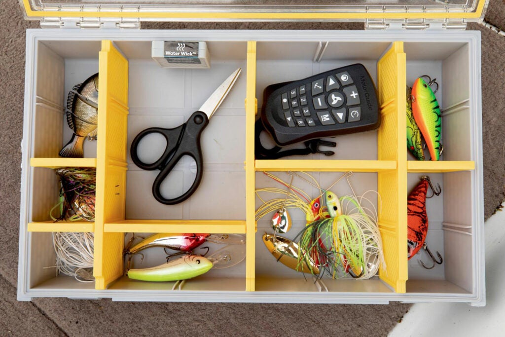 A drawer of tools and lures fitted with yellow custom dividers