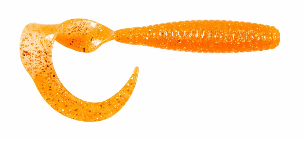 An orange fishing worm lure on a white background.