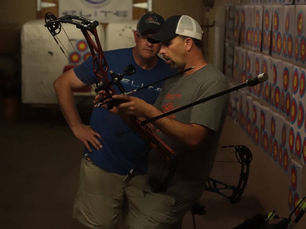 Two men in a bow shot at Elite Archery.
