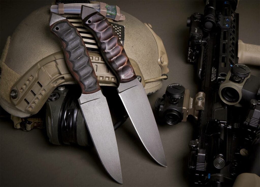 Two bladed winkler knives on a military helmet.